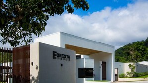 A modern building with a sign reading "FORESTA RESIDENCES". - Captivating 2-bed Apartment (Jacó)
