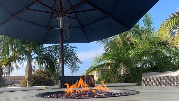 An outdoor fire feature with a metal frame and a blue canopy overhead. - Beach House, 4 Blocks to Ocean/Bay+ BBQ & Firepit! (San Diego)