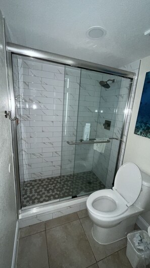 Bathtub, towels, soap, toilet paper