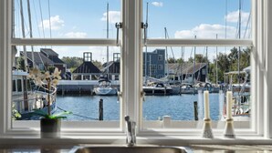 A marina with boats docked, a building with a sloped roof, and a clear sky. - Stunning home in Ebeltoft with sauna (Ebeltoft)