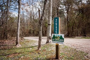 A signpost with a number '29477' and a sign for 'Lazy Lane Cabins Buckeye Bungalow.'