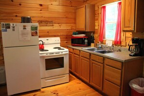 Enjoy cooking in this fully equipped kitchen with a refrigerator, stove, oven, microwave, sink, and coffee maker.