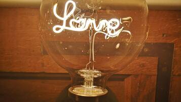 A clear glass globe with the word "Lounge" written inside, mounted on a wooden base.
