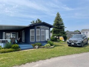 Situated in a quiet suburban neighborhood, this single-story house offers a front porch and a well-manicured lawn.
