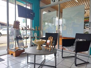 A modern interior with a round table, two chairs, and a display of sculptures.
