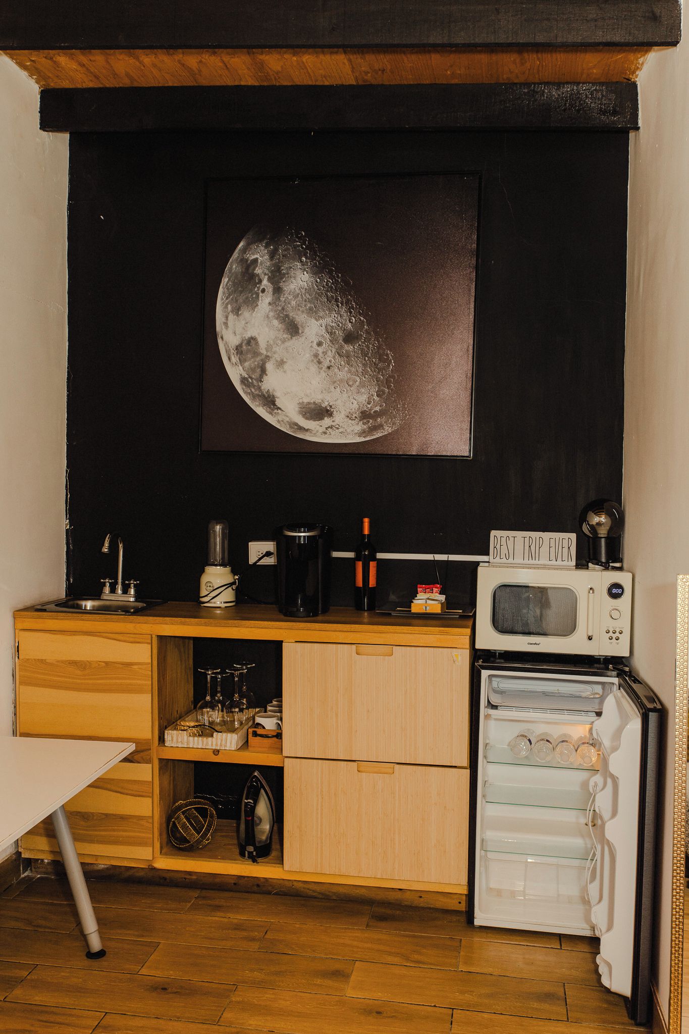 A compact kitchen with a microwave, a coffee maker, and a refrigerator.