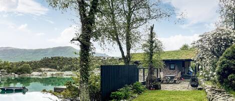 Enjoy a serene lakeside setting with a view of the lake and distant hills.