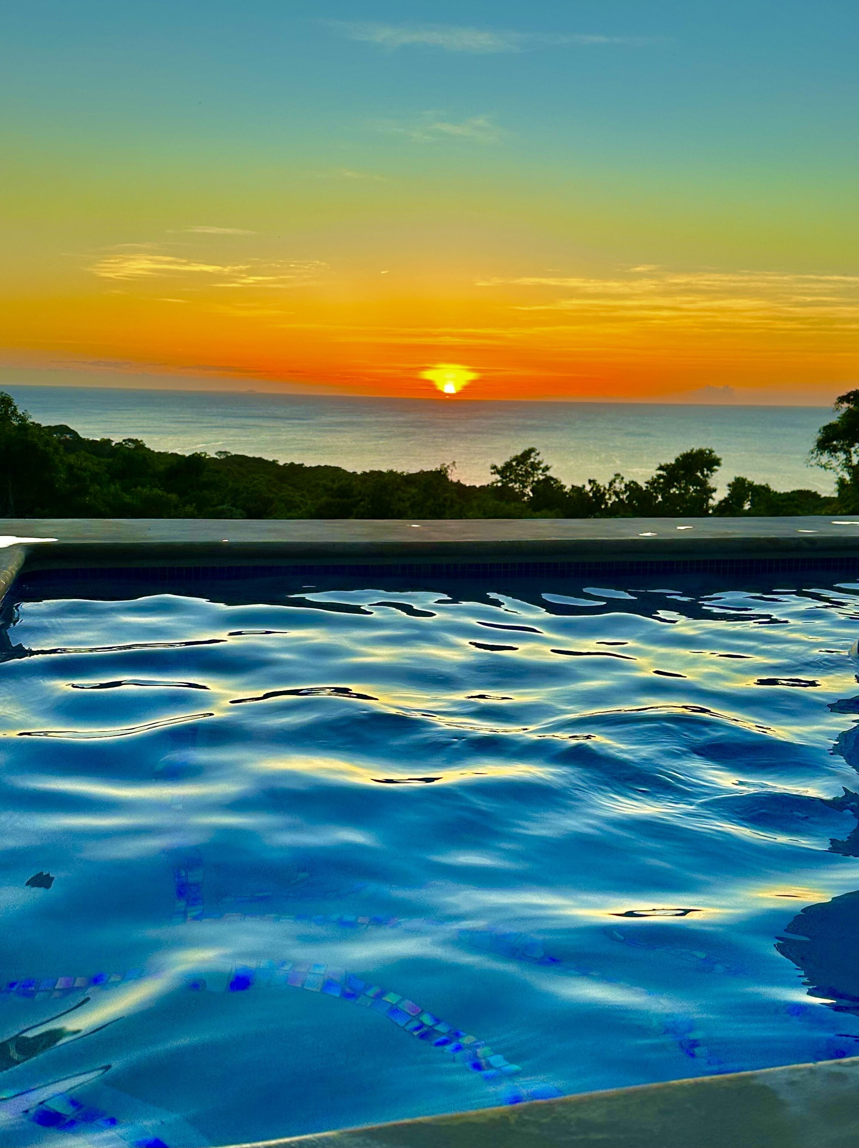 A swimming pool with a sunset view.