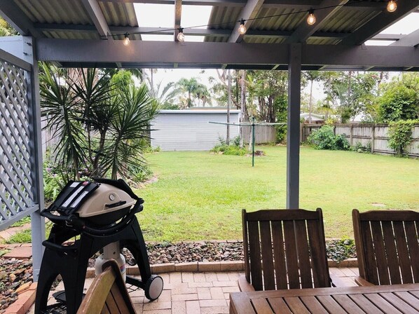 Enjoy al fresco dining in this outdoor space with a grill and seating for two.