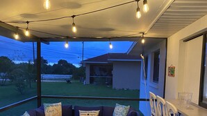 An outdoor patio with a sofa set, a dining table, and chairs. - Cozy, Clean, Convenient With A Beach Feel (Cape Coral)