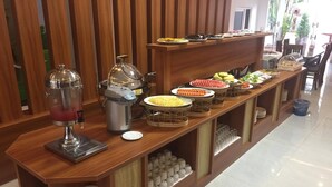 A buffet setup with various food items and a beverage dispenser. - Vientiane Garden Villa Hotel (Vientiane)