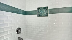 A bathroom with white subway tiles, a green and black patterned tile accent, and a modern faucet. - 🏖 Beautiful Bay View Condo “Close To Beach” 🏖 (Ventnor City)
