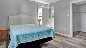 A bedroom with a bed, a nightstand, a lamp, and a closet. - 🏖 Beautiful Bay View Condo “Close To Beach” 🏖 (Ventnor City)