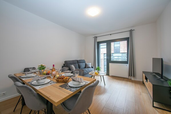Enjoy meals with family and friends at the dining table, surrounded by a comfortable seating area.
