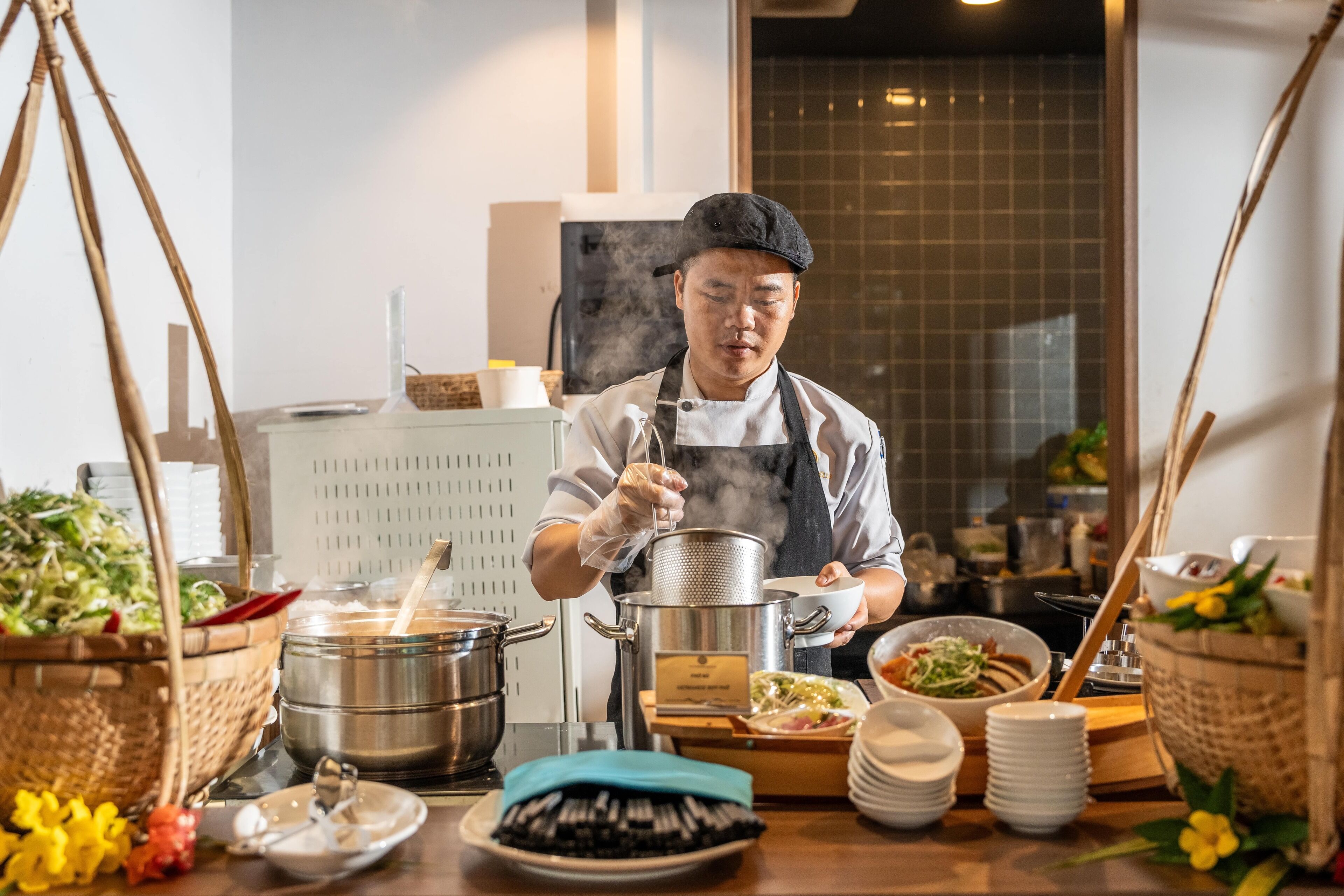 A buffet setup with various dishes and cooking equipment.