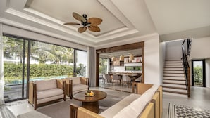 A spacious living area with a sofa, coffee table, and a ceiling fan. - Andochine Resort & Spa Phu Quoc (Phu Quoc)