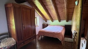 A bedroom with a wooden ceiling, a bed, a wardrobe, and a chair. - Mont Blanc, Amazing View From Private Terrace (Cogne)