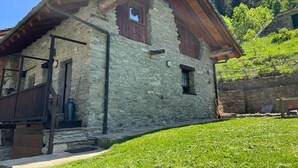 A stone building with a sloped roof, wooden beams, and a small window. - Mont Blanc, Amazing View From Private Terrace (Cogne)