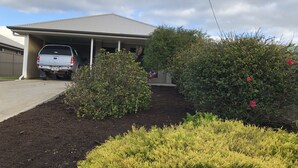 A residential garage with a white pickup truck parked inside.