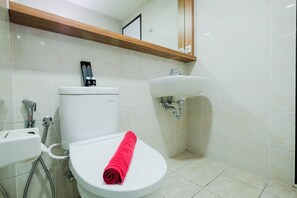 A bathroom with a toilet, sink, and shower. - Scenic 1Br Apartment At Mustika Golf Residence (Cikarang)
