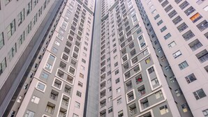 A high-rise building with multiple floors, featuring balconies and windows.