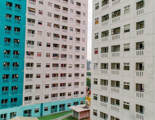 A multi-story residential building with balconies and windows.