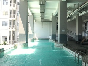 Outdoor pool - Well Appointed 1BR Apartment at Harvard Jatinangor (Cileunyi)