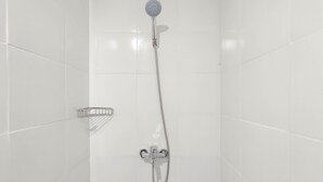 A shower with a handheld showerhead and a handheld shower attachment. - Good Deal 1Br At Paltrow City Apartment (Semarang)
