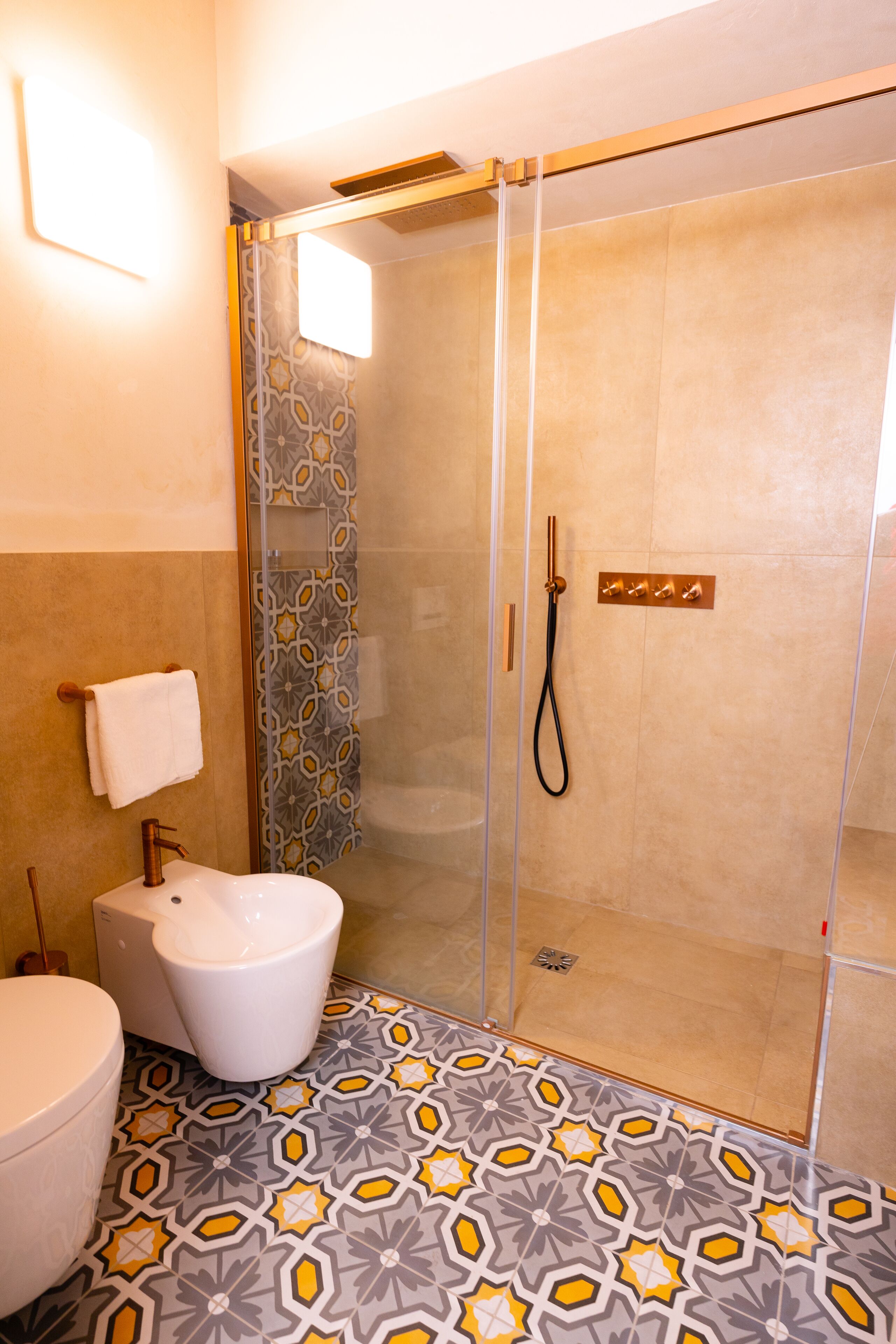 A bathroom with a shower, toilet, and sink.