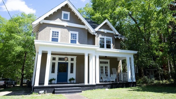 A two-story house with a front porch, a garage, and a small front yard. - Made for the trips that bring everyone together. This historic Montgomery home gives families, wedding parties, and groups room to gather, room to disappear for a while, and one place to come back to—all minutes from downtown, Maxwell AFB, and the re (Montgomery)