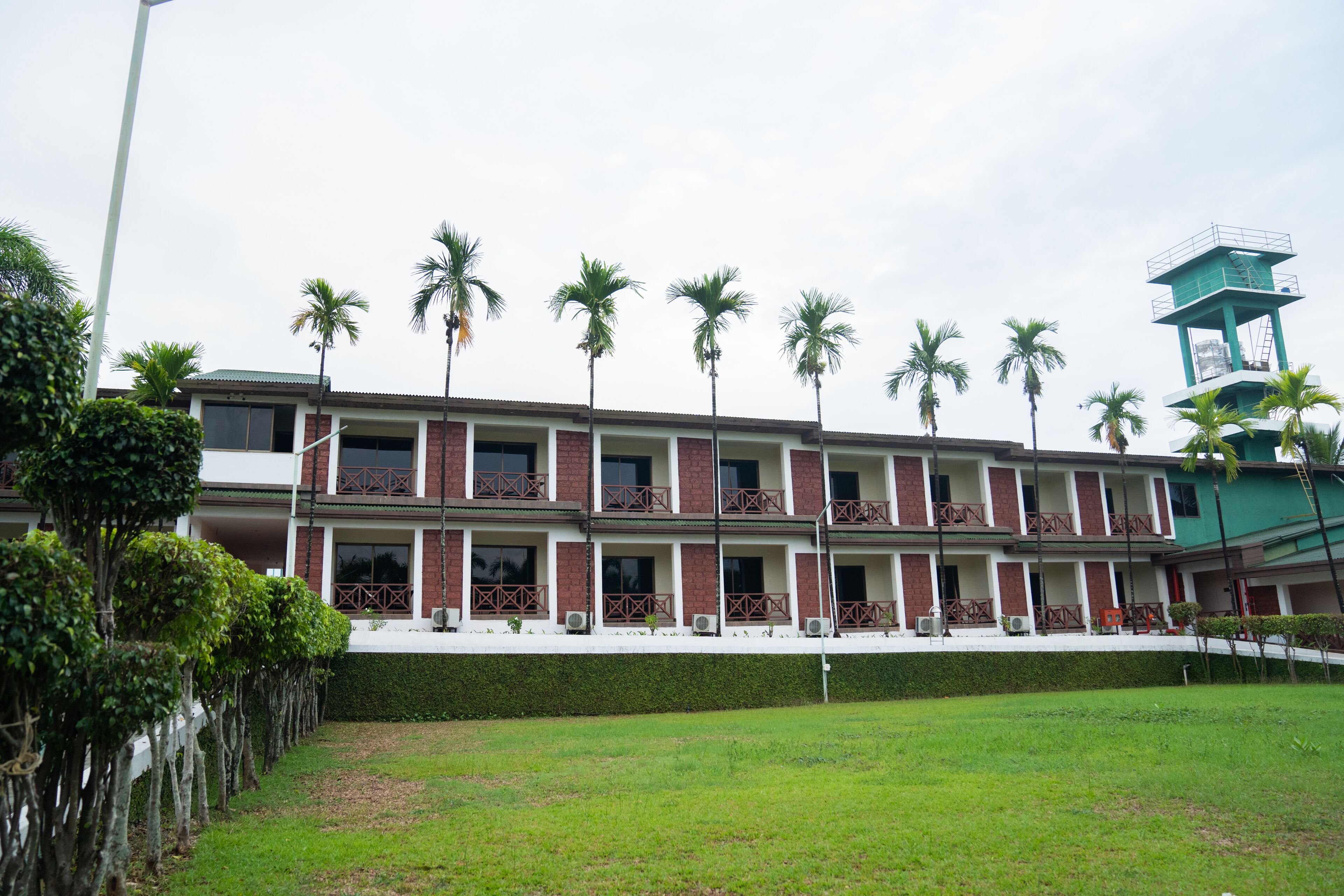 A multi-story hotel with a consistent architectural style, featuring balconies and a central tower.