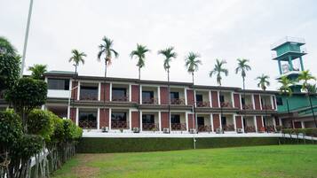 A multi-story hotel with a consistent architectural style, featuring balconies and a central tower.