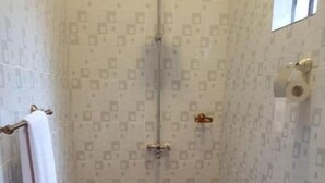 A bathroom with a toilet, sink, and shower. The floor has a patterned tile design, and there is a towel rack with a towel hanging on it. - Stay.Plus Villa Serene Hotel Kitale (Kitale)