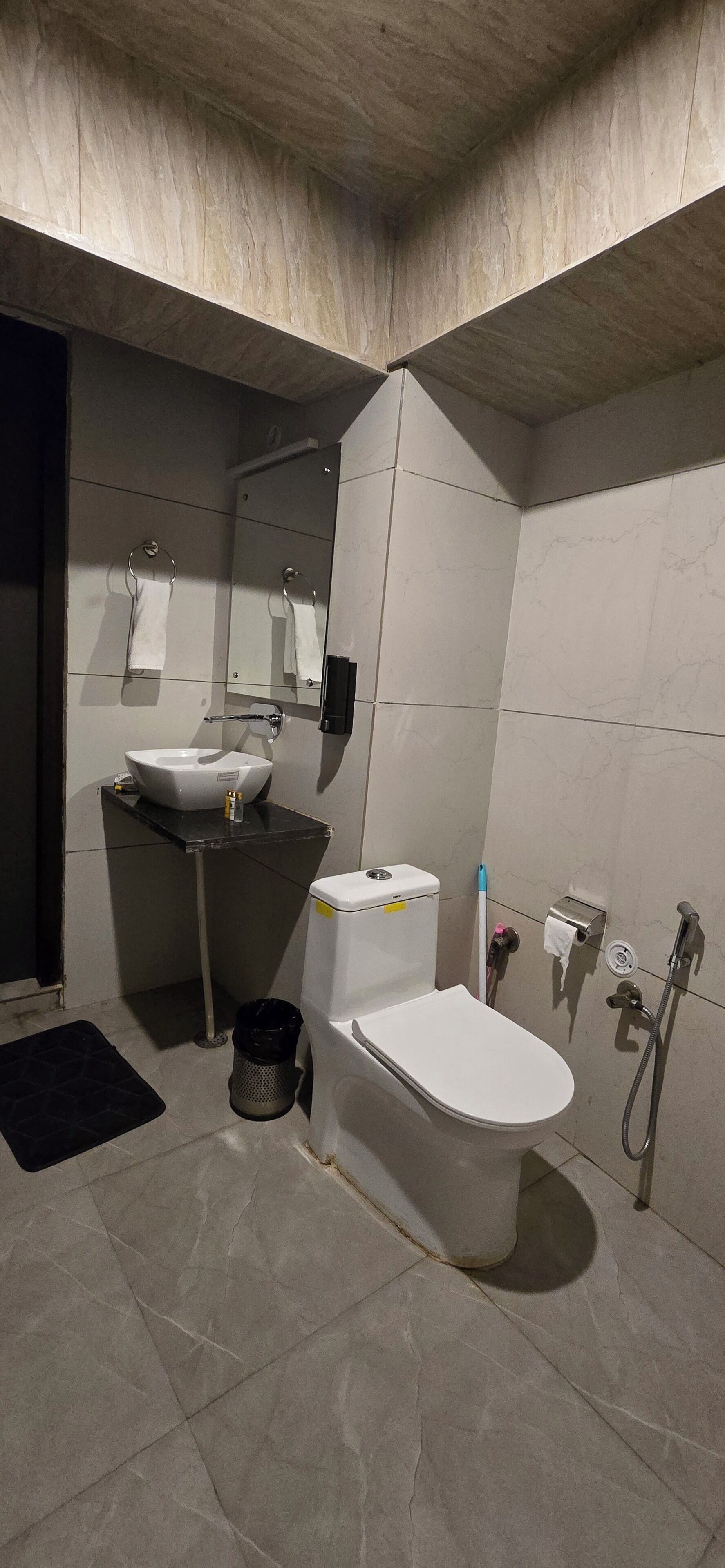 A modern bathroom with a toilet, sink, and shower.