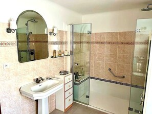 Bathtub, hair dryer, towels, toilet paper