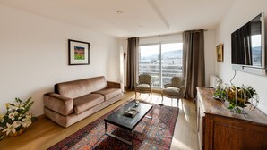 A modern living room with a sofa, chairs, a coffee table, and a large window with curtains. - Le Kaliste*** - apartment for 4 people + garage (Annecy)