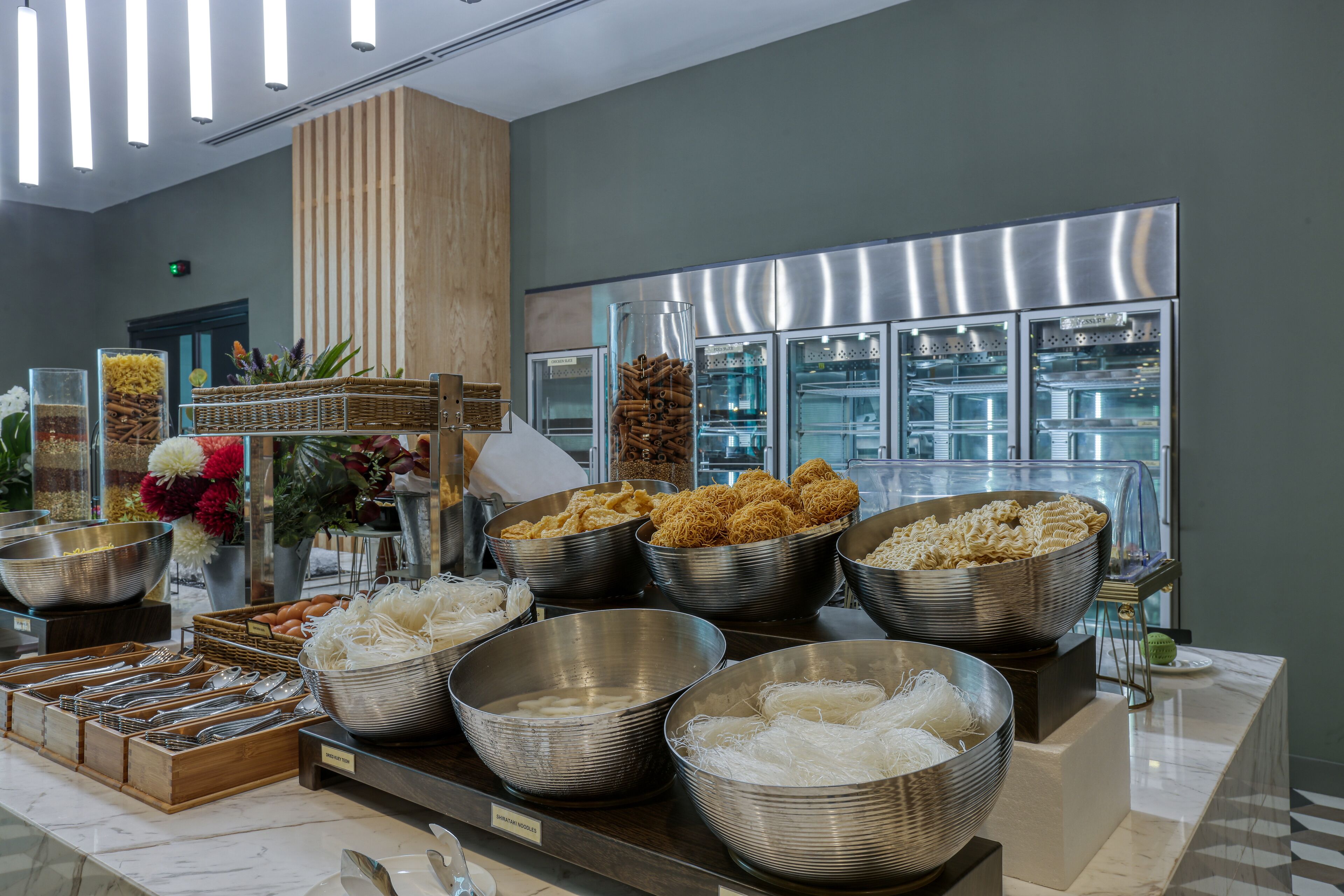 A buffet with various food items and utensils.
