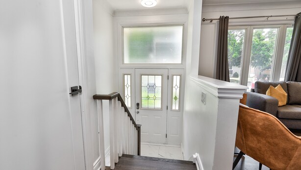 A staircase leading to a door with a window above it.