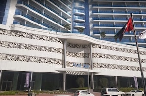 A modern hotel with a distinctive facade featuring geometric patterns and balconies.