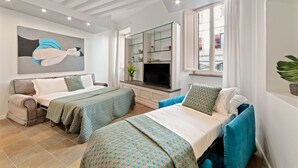 A modern hotel room with two beds, a large window, a flat-screen TV, and a painting on the wall. - ViaPaola43 Palace 1st floor 2Bdr (Roma)