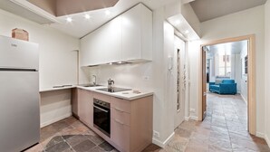 A modern kitchen with a built-in oven, a refrigerator, and a sink. - ViaPaola43 Palace 1st floor 2Bdr (Roma)