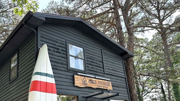 A small wooden building with a sign reading 'Mike House.'