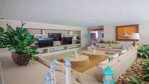 A modern living room with a sofa, coffee table, and potted plants. - Reserva Del Mar 624 (Santa Marta)