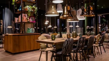 A modern dining area with a wooden table, patterned chairs, and pendant lighting.