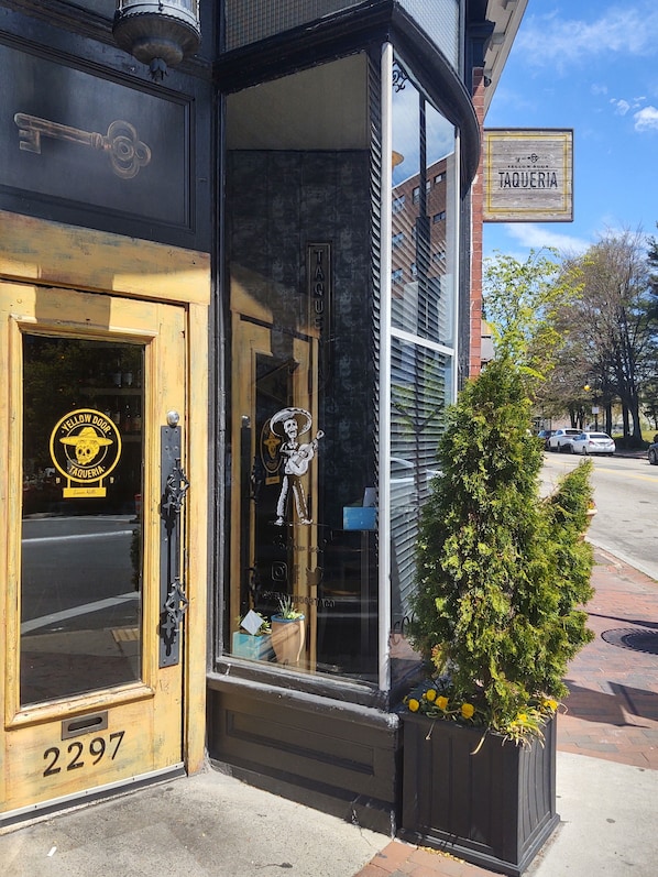 A building with a sign reading "TAQUERIA" and a door labeled "YELLOW DOOR".