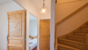 A wooden staircase leading to a bedroom with a bed and a nightstand. - Apt 8 ppl, balcony, near the ski runs, parking (Orcières)