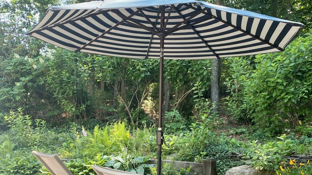 A deck with two lounge chairs and a large striped umbrella. - Newly renovated Modern East Hampton Home / September available (East Hampton)