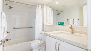 A modern bathroom with a bathtub, toilet, and sink. - Second Floor Ocean View Studio – Gorgeous Waterfront Escape (Islamorada)