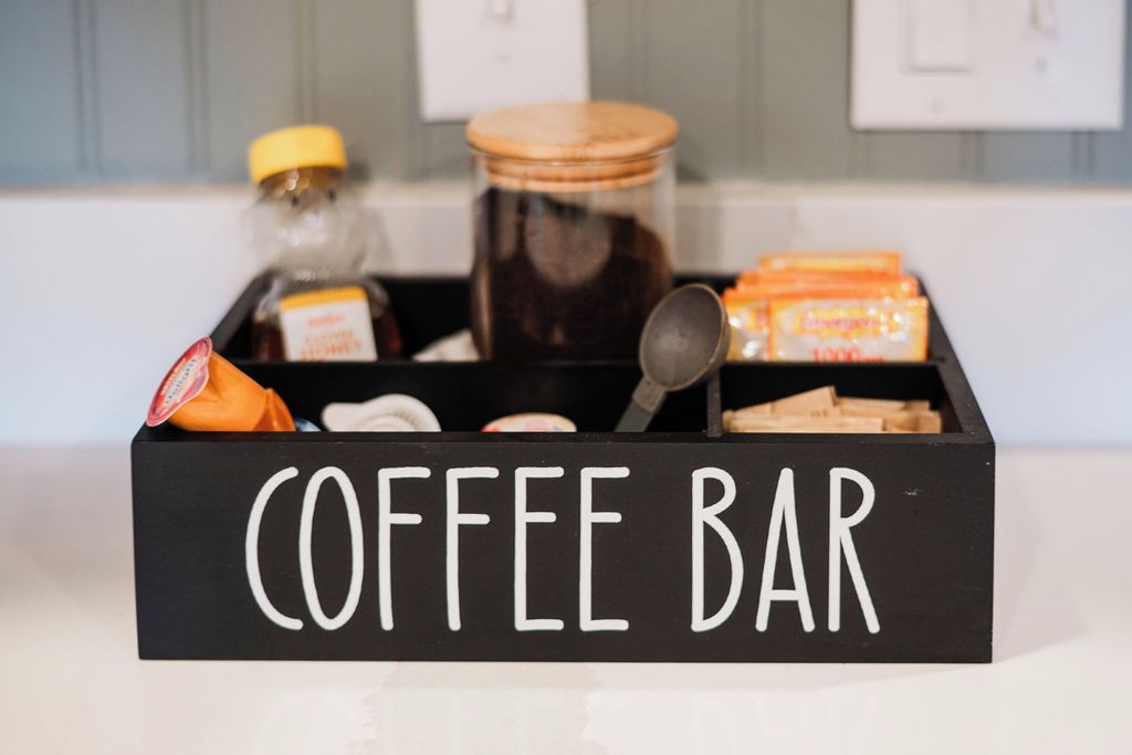 A black box labeled "COFFEE BAR" containing various coffee-related items.