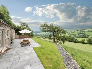 A stone building with a patio, outdoor seating, and a view of rolling hills. - Upper Valley Barns - Six Bedroom Villa, Sleeps 14 (Hirnant)
